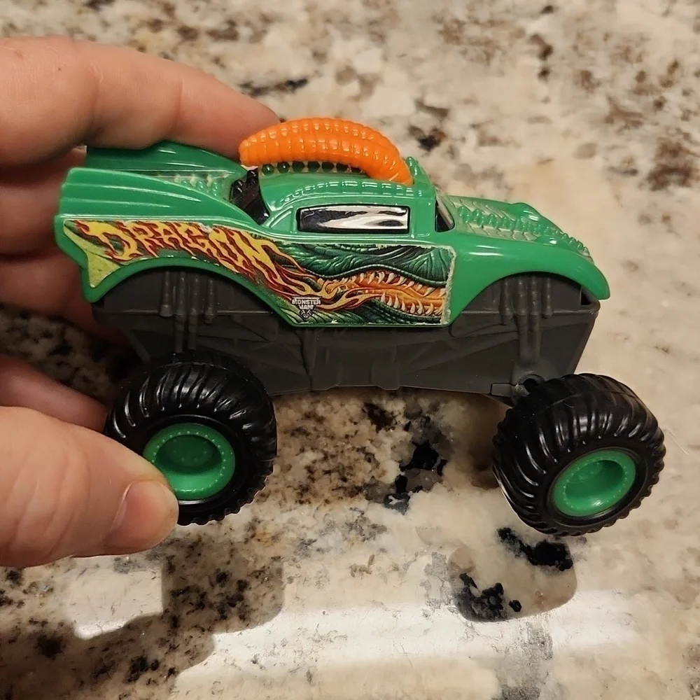 Monster jam plastic Rev up trucks has paper stickers ripping 2 cars